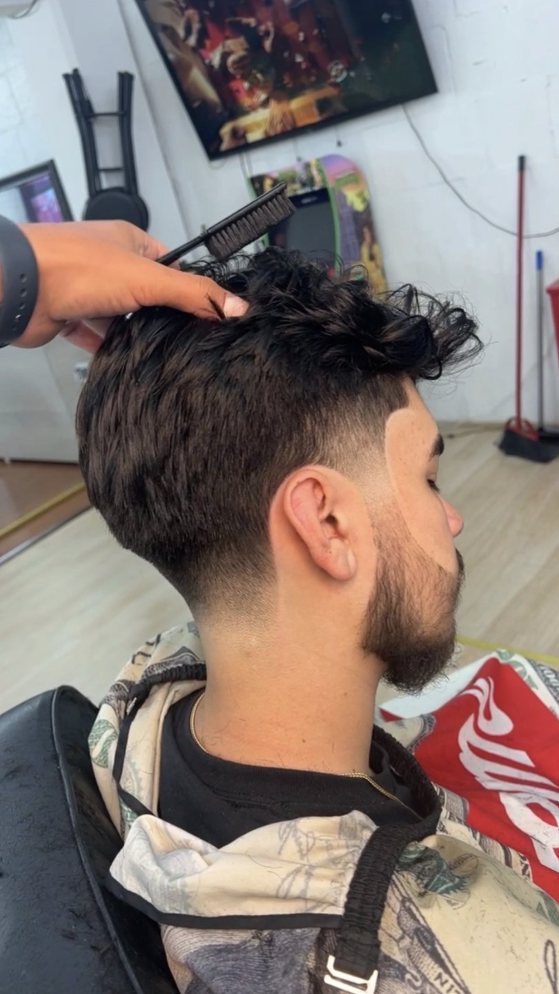 Taper fade with a curly top at VIC-TORY Barbershop West Chester PA